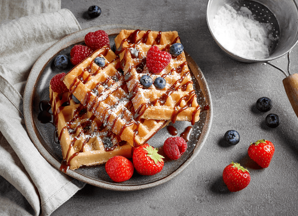 Belgian waffles with fresh berries and chocolate syrup